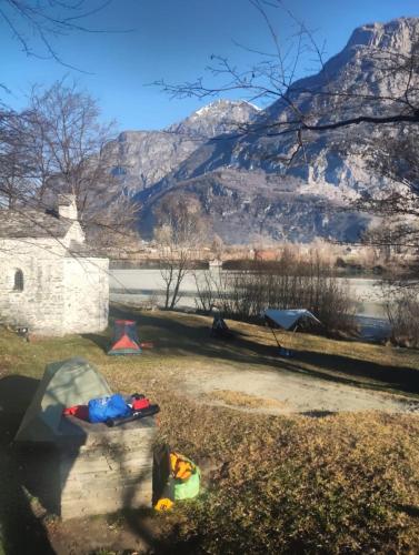 a park with a mountain in the background at San Carlo in Chiavenna