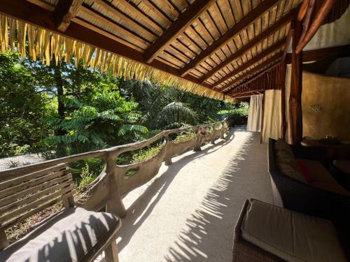 a row of benches sitting under a wooden roof at Casa Vida Verde in Cabo Matapalo