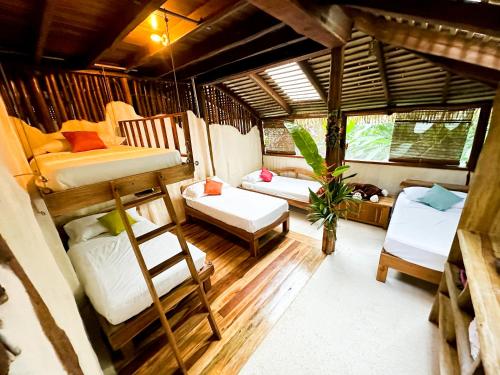 a room with two bunk beds and a couch at Casa Vida Verde in Cabo Matapalo