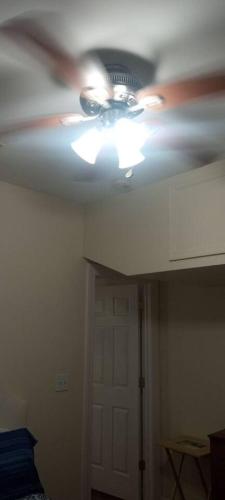 a ceiling fan in a room with a door at the rest spot in Schenectady