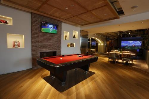 a billiard room with a red pool table in it at WM Hotel Hong Kong, Vignette Collection in Hong Kong