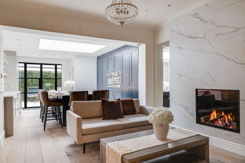 a living room with a couch and a fireplace at The Racecourse Garden Collection in Chester