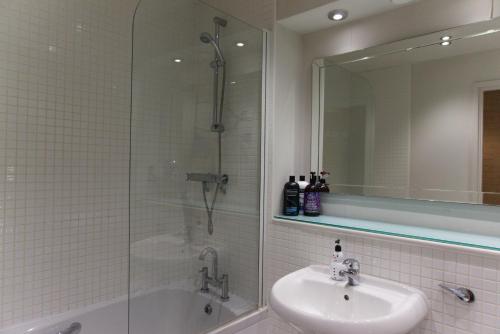 a bathroom with a shower and a sink and a tub at Russet Quarter, Parking subject to availability in York