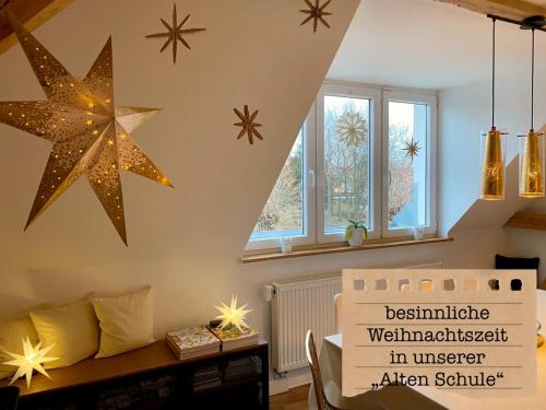 a living room with stars on the wall at ALTE SCHULE WITTENBERG, 3 Ferienwohnungen für bis zu 12 Personen, an der Elbe, mit Garten in Lutherstadt Wittenberg
