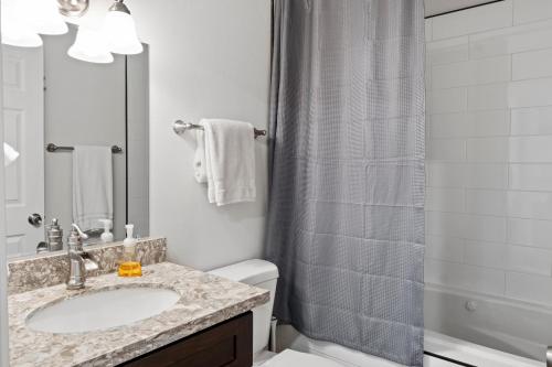 a bathroom with a sink and a shower at Mt. Rainier Cabin w/hot tub in Ashford