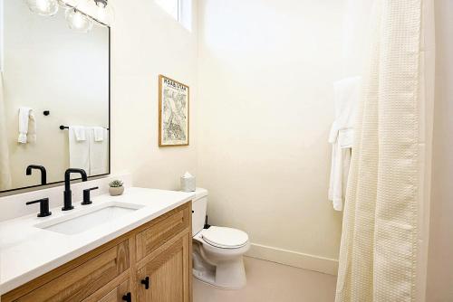 a white bathroom with a sink and a toilet at Downtown Kokopelli West 5 - Newly Remodeled Stylish Studio in Moab