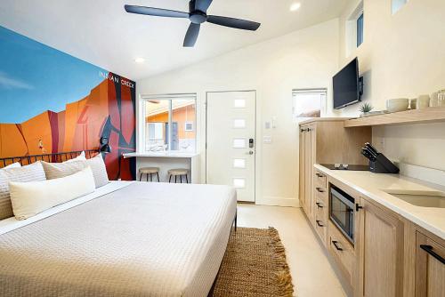 a bedroom with a bed and a ceiling fan at Downtown Kokopelli West 6 - Newly Remodeled Stylish Studio in Moab