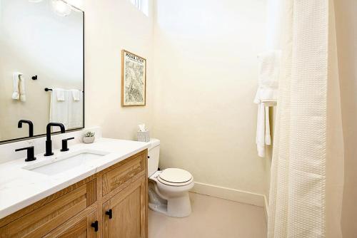 a white bathroom with a sink and a toilet at Downtown Kokopelli West 6 - Newly Remodeled Stylish Studio in Moab