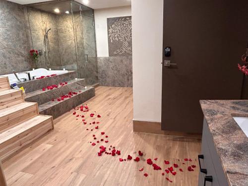 a bunch of red roses on the floor of a bathroom at Luxury suite with Sauna and Spa Bath - Elkside Hideout B&B in Canmore