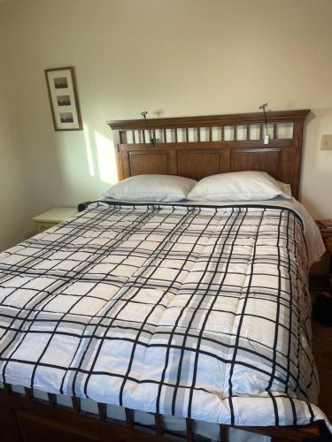 a bedroom with a bed with a blue and white comforter at Country relaxation in Naches