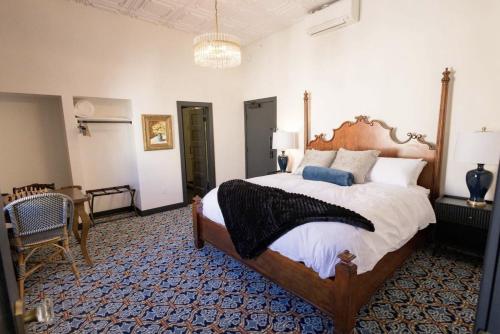 a large bedroom with a large bed and a chair at Speakeasy 2 Room Suite (Rm 4) in Nevada City