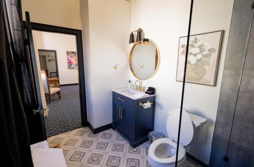 een badkamer met een toilet, een wastafel en een spiegel bij Speakeasy 2 Room Suite (Rm 4) in Nevada City