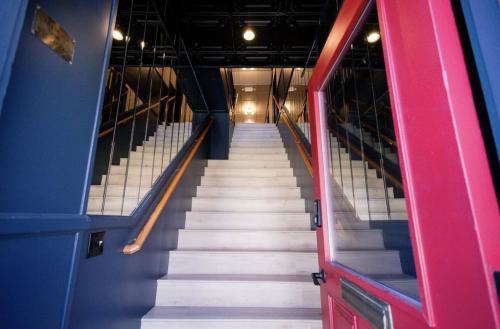 a stairway with white stairs in a building at Speakeasy 2 Room Suite (Rm 4) in Nevada City