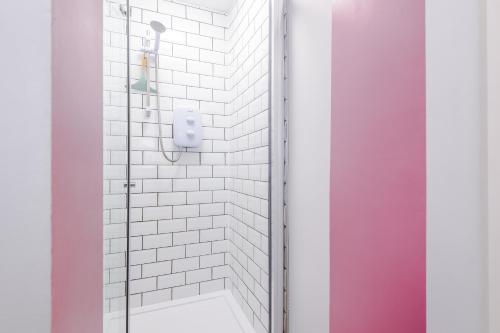 a bathroom with a shower with white tiles at NEW! Stunning City-Centre Home by 53 Degrees Property, ideal for Couples, Amazing Location! in Chester
