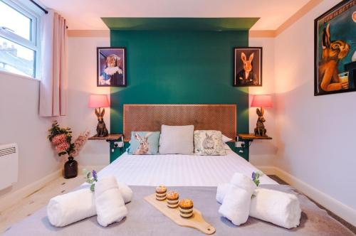 a bedroom with a bed with a green wall at NEW! Stunning City-Centre Home by 53 Degrees Property, ideal for Couples, Amazing Location! in Chester