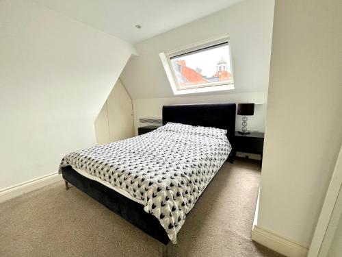 a bedroom with a bed and a window at Central Morden, Westfield, close to Tube station in London