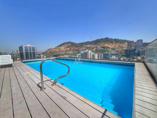 a swimming pool on the roof of a building at Apartamentos City Centro Manuel Montt in Santiago