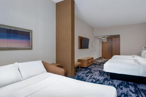 a hotel room with two beds and a tv at Fairfield by Marriott Inn & Suites Indianapolis Plainfield in Plainfield