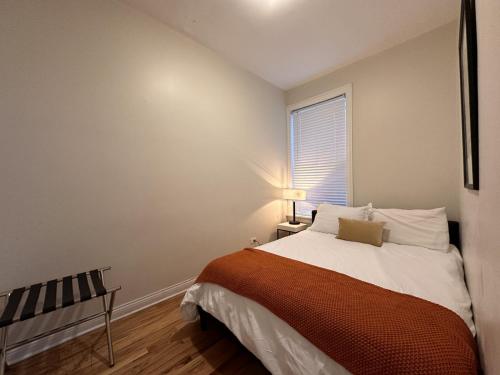 a small bedroom with a bed and a window at Flexhome Wicker Park 2BR DV3 - READ INFO in Chicago