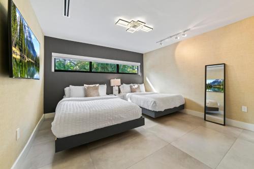 a bedroom with two beds and a large window at Stylish Haven Heated Pool Pool Table L28 in Cutler Bay