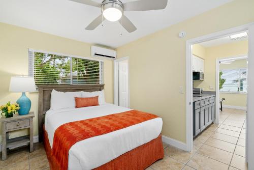 a bedroom with a large bed and a kitchen at Bay Harbor Lodge in Key Largo