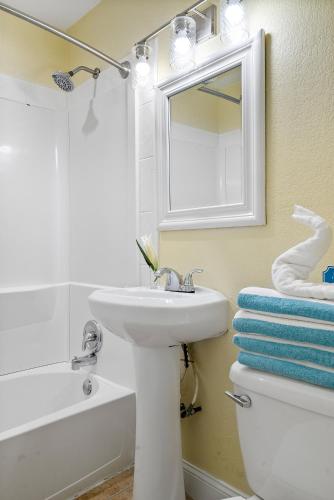 a white bathroom with a sink and a mirror at Bay Harbor Lodge in Key Largo