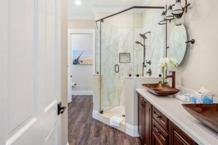 a bathroom with a shower and a sink and a mirror at Papa's Abode by Brightwild-Huge Home & Pool in Stock Island