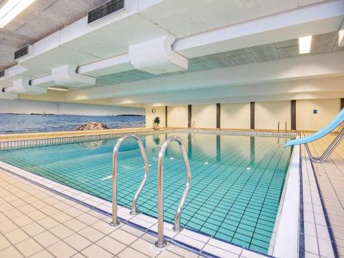 a swimming pool with green tile floors and a swimming pooliterator at 6 person holiday home on a holiday park in Faaborg in Fåborg