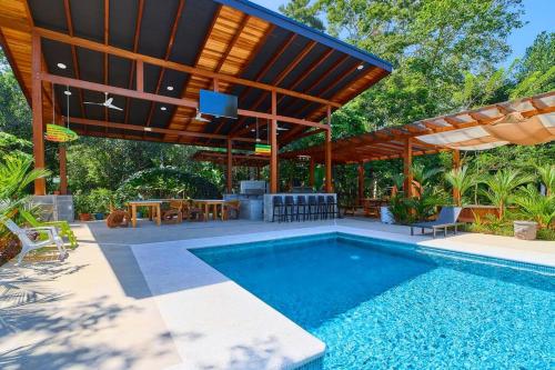 a swimming pool with a pavilion and a patio at Casa Kristel - Exquisite Villa Getaway in Puerto Viejo