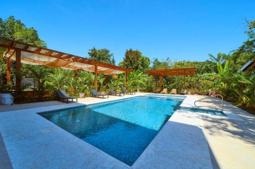 a swimming pool in a backyard with at Casa Kristel - Exquisite Villa Getaway in Puerto Viejo