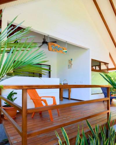 a wooden deck with a table and a bench at Casa Kristel - Exquisite Villa Getaway in Puerto Viejo