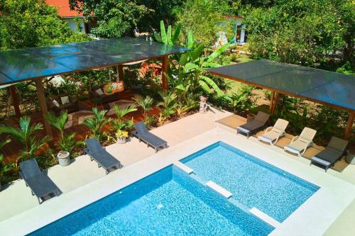 an overhead view of a swimming pool with chairs at Casa Kristel - Exquisite Villa Getaway in Puerto Viejo