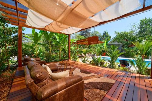 a living room with a couch and an umbrella at Casa Kristel - Exquisite Villa Getaway in Puerto Viejo