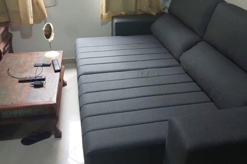 a blue couch in a living room with a table at Apartamento bambu Laranjeiras in Rio de Janeiro