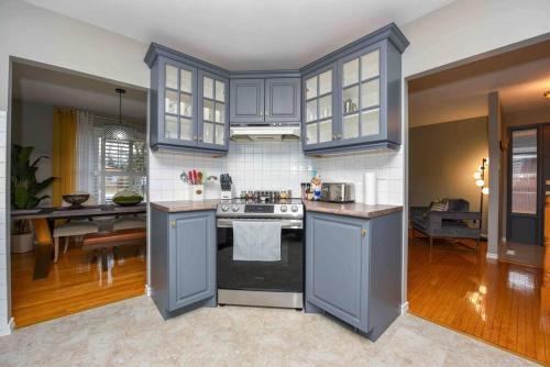 a kitchen with blue cabinets and a counter top at Bright & Cozy 4BR Home for Your Family Stay With Optional Pool Access in Mississauga