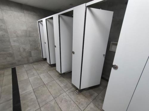 a row of white stalls in a bathroom at PataPalo in Arrecife