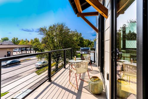 a balcony with a table and a view of a street at Lupfer Luxury in Whitefish