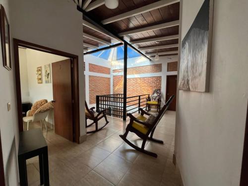 Una sala de estar con dos sillas y un sofá. en La Palapa & Posada Mía, en Alto de Tío Diego