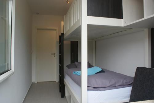 a bedroom with a bunk bed in a room at Strandhaus Rose in Juist