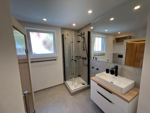 a bathroom with a sink and a shower at Dünen Lodge 1 in Juist