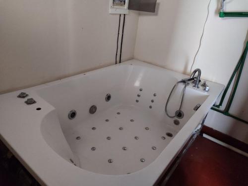 y baño con bañera blanca grande. en Villa Candida, en Encarnación