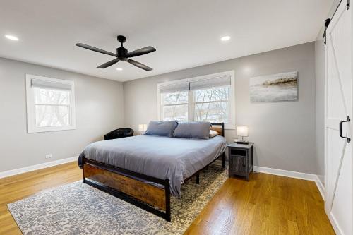 a bedroom with a bed and a ceiling fan at Casa de Nello - Upper Level in Antioch