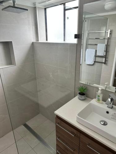 a bathroom with a shower and a sink at Queensleigh Holiday Apartments in Gold Coast