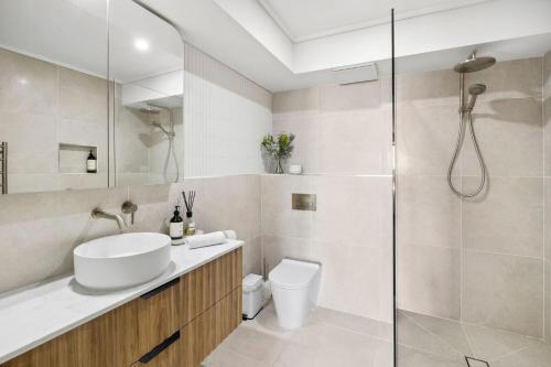 uma casa de banho com um WC, um lavatório e um chuveiro em Apartment 12 Pacific Apartments em Lorne