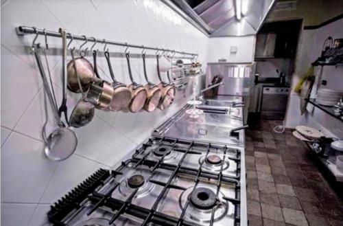 a kitchen with a stove top oven in a kitchen at Rome villa swimming pool in Campagnano di Roma