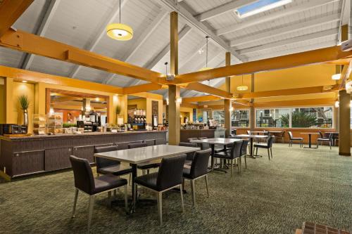 a restaurant with tables and chairs and a bar at Best Western The Plaza Hotel Honolulu Airport - Free Breakfast in Honolulu