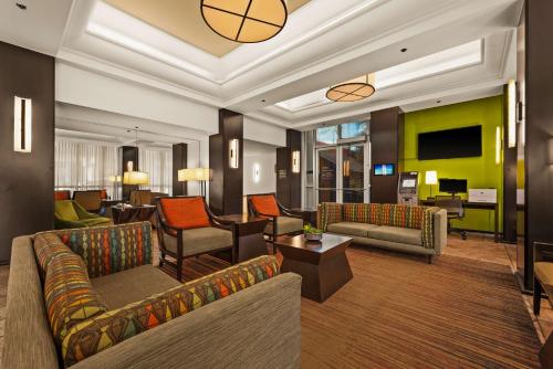 a living room with couches and a basketball on the wall at Best Western The Plaza Hotel Honolulu Airport - Free Breakfast in Honolulu
