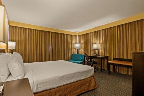 a hotel room with a bed and a desk at Best Western The Plaza Hotel Honolulu Airport - Free Breakfast in Honolulu