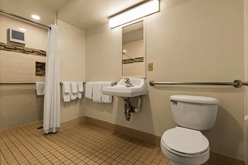a bathroom with a toilet and a sink at Best Western The Plaza Hotel Honolulu Airport - Free Breakfast in Honolulu