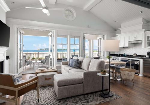 a living room with a couch and a kitchen with the ocean at Beach Village at The Del, LXR Hotels & Resorts in San Diego